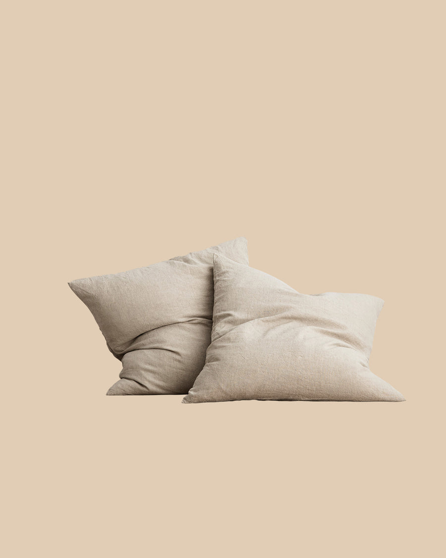 two natural light brown pre-washed linen Euro pillowcases on bed