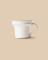 elegant white handmade dishwasher safe ceramic tea cup with green rim side view