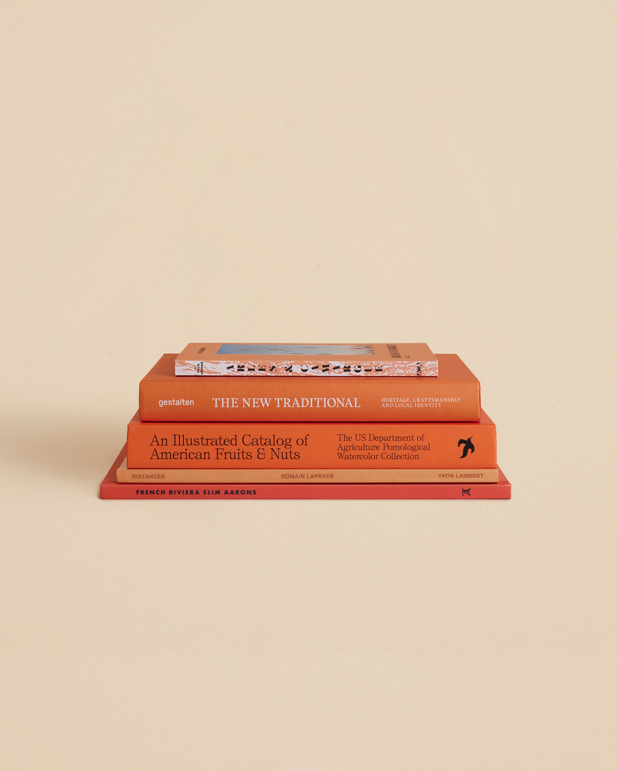 five one-of-a-kind decorative books about food, travel, art, photography with orange covers 