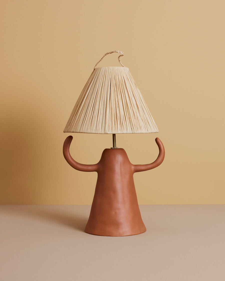 handmade Mediterranean terracotta table lamp with sculptural ceramic cone-shaped base and straw shade