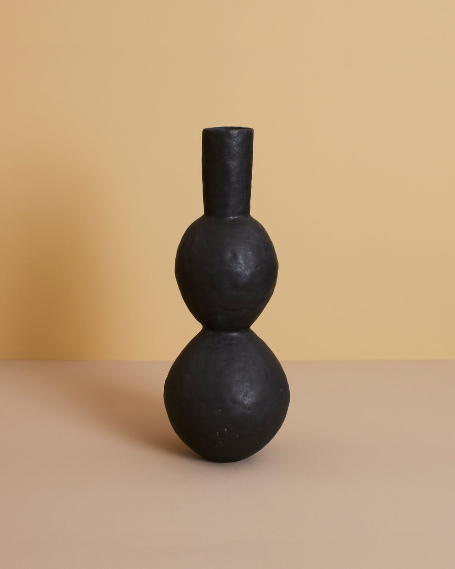 stylized image of 18.5 inch tall handcrafted black modern double-curved artisan clay vase