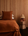 two terracotta pre-washed linen Euro pillowcases on bed