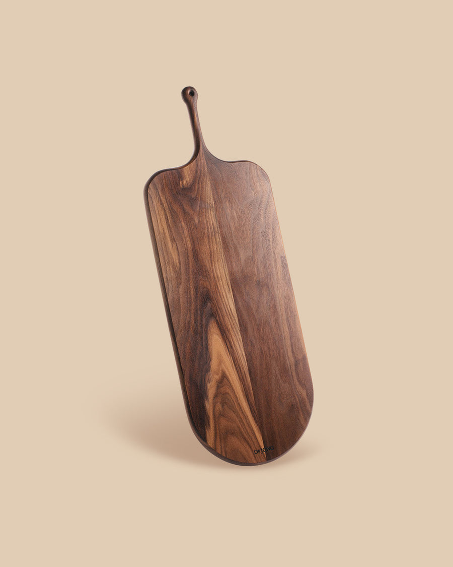 long paddle-shaped solid handcrafted artisan walnut wood serving board 