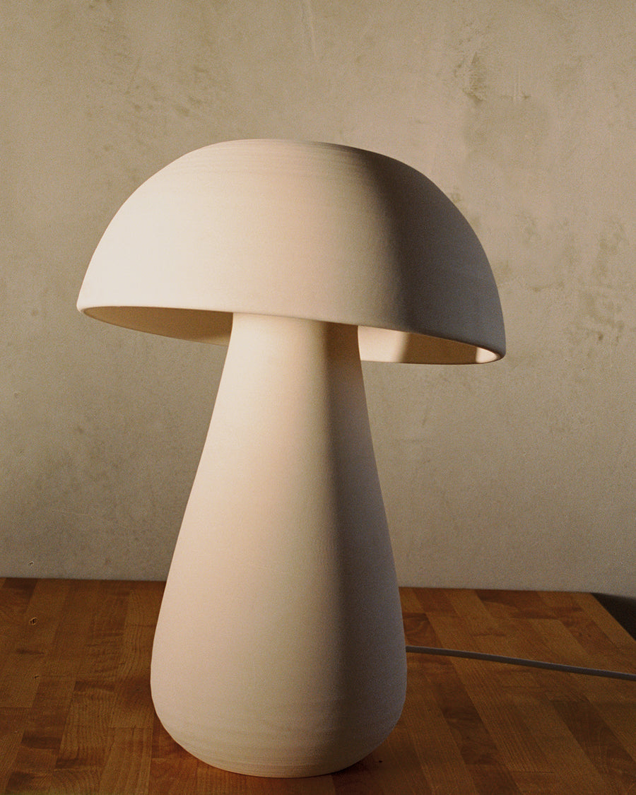 cozy handcrafted ivory ceramic mushroom-shaped table lamp with ambient lighting