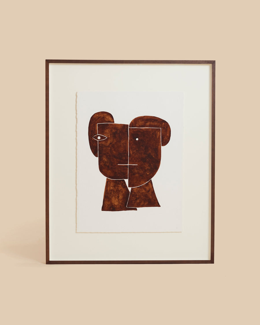 Framed watercolour by Hermentaire, two rust-brown faces in mirrored profile, floated on a wide cream mount in a slim dark frame