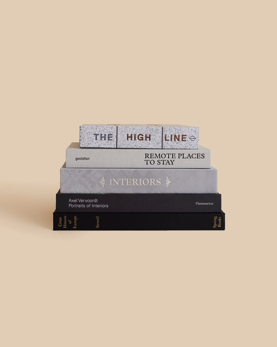 The Places and Spaces Book Stack by Maison Plage for Arjé, five grey and black books on interiors, architecture and remote places to stay