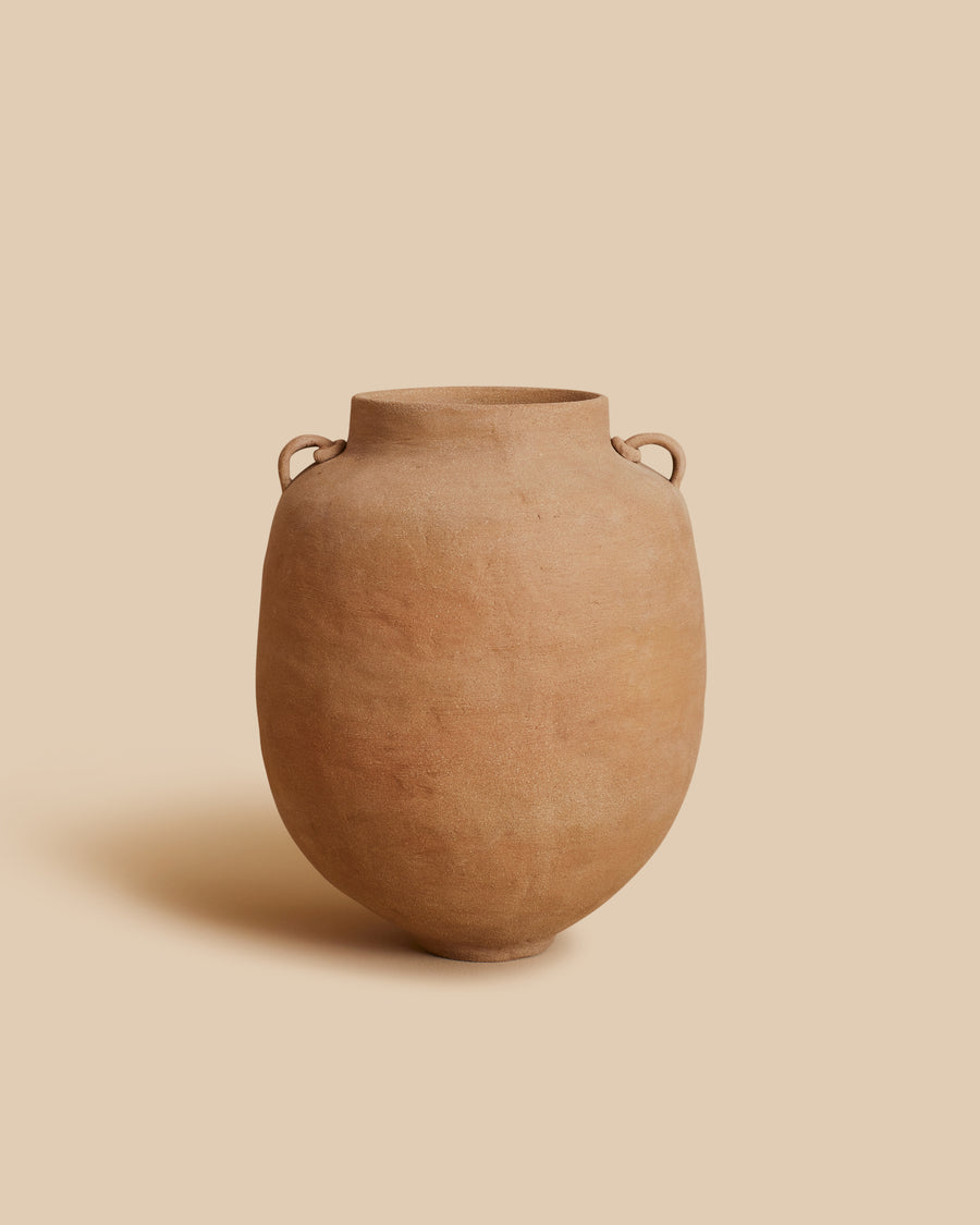 Column Vase by Marta Bonilla, a rounded terracotta jar with two small handles at the neck, shaped like a Mediterranean olive oil vessel