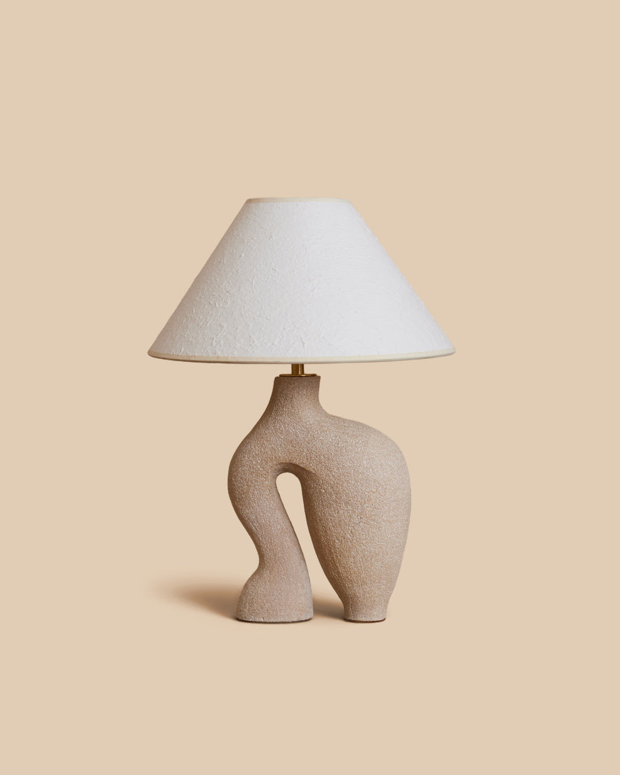 sand-colored abstract sculptural ceramic table lamp with ivory rice paper shade
