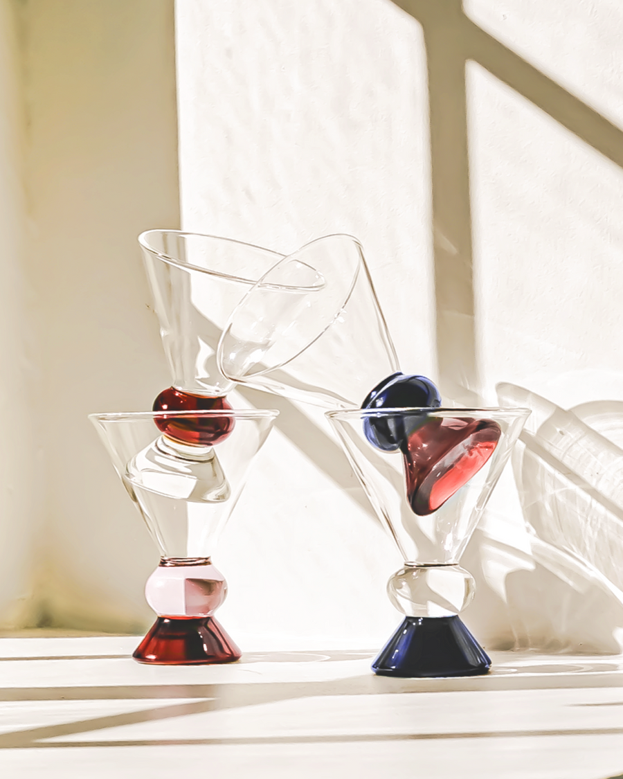 Sophie Lou Jacobsen Totem Glasses in two colors – clear and black base, with a smooth cone shape and solid base, ideal for spritzes and cocktails.
