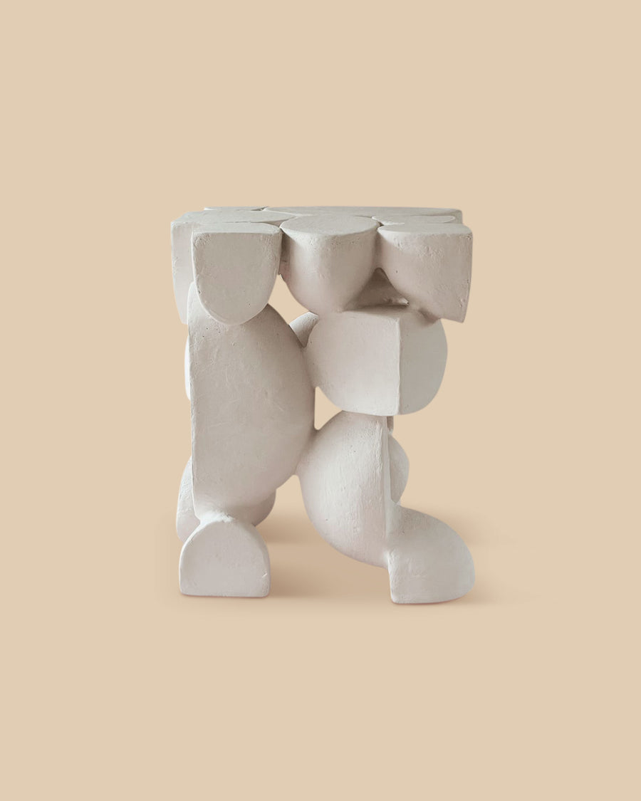 white raw clay versatile sculptural ceramic side table intricate shapes and forms.