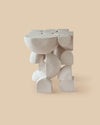 white raw clay versatile sculptural ceramic side table intricate shapes and forms.