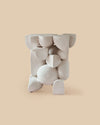 white raw clay versatile sculptural ceramic side table intricate shapes and forms.