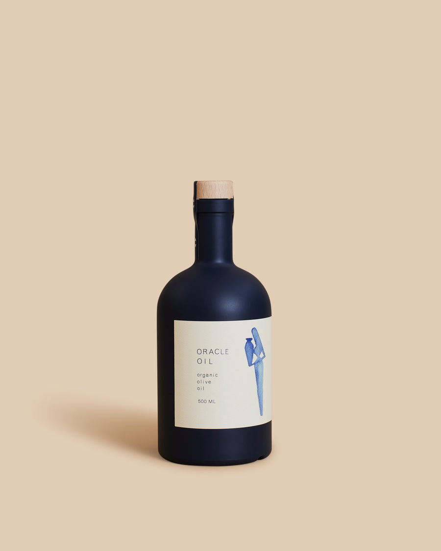 Oracle Olive Oil, an indigo 500ml bottle of organic Greek Koroneiki olive oil with a wooden cap and a cream label drawn with a small blue figure