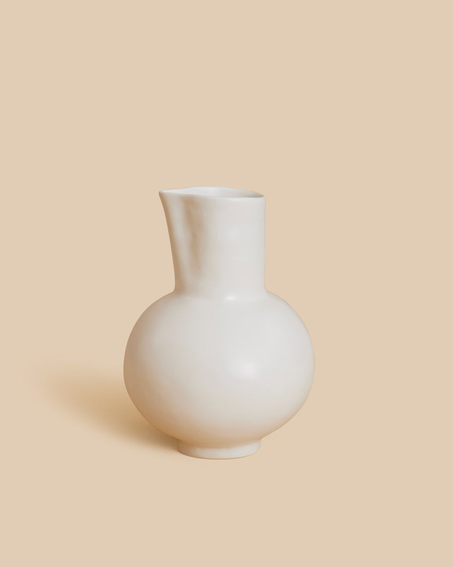 Pitcher by Marta Bonilla, a white hand-modelled stoneware pitcher with a round belly and a pinched spout