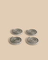 A set of four spiral coasters, showcasing their sand-cast aluminum structure and shiny nickel coating.