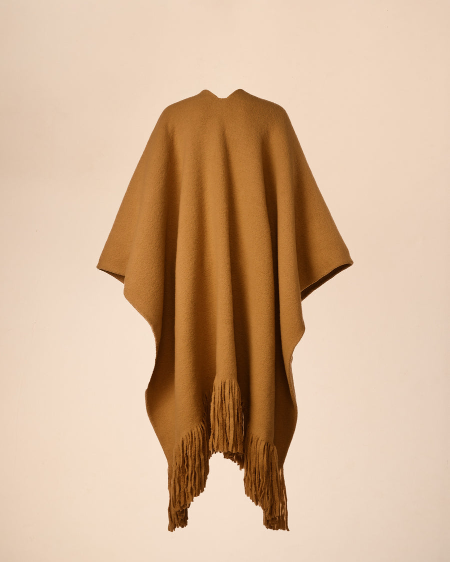 Soft alpaca and wool blend cape coat, exaggerated fringes, versatile for winter to spring, includes a waist belt and hand-stitched seams.