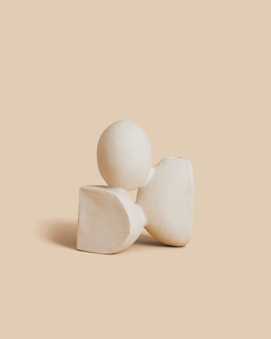 Velas N.30 by Re Jin Lee, a small white ceramic sculpture of three rounded forms, one balanced above the others
