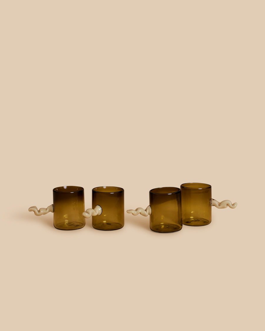 Wiggle Cup Set by Sticky Glass in smoke and cream, four hand-blown olive-brown cups with white squiggle handles