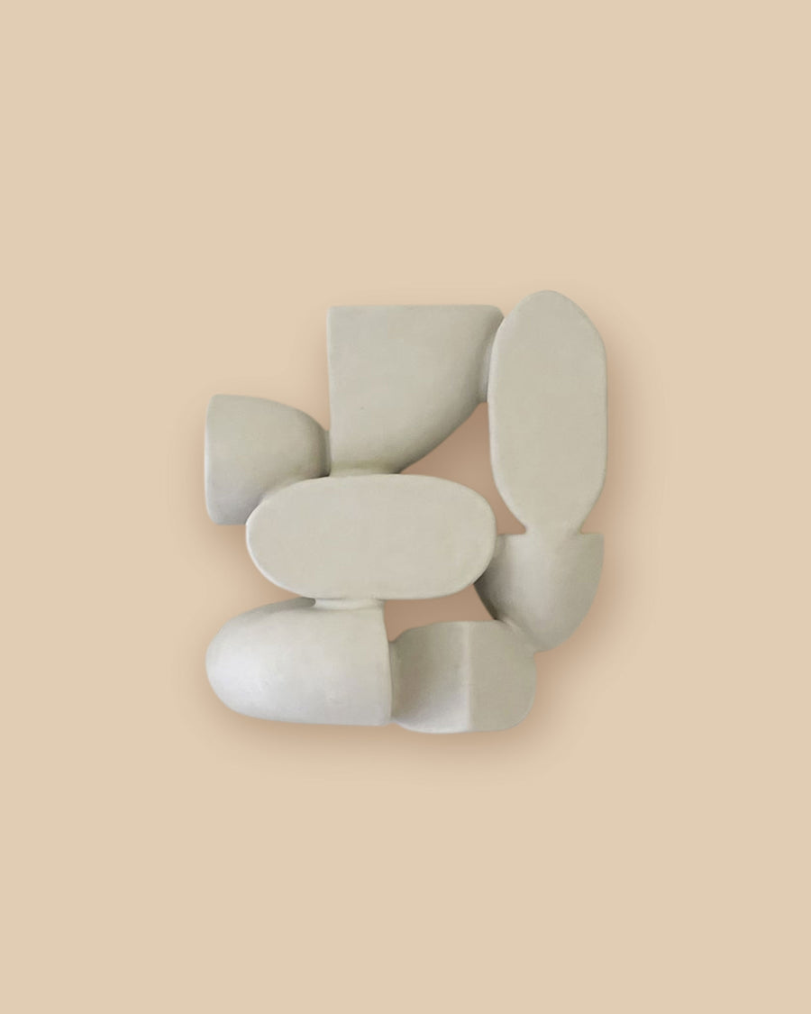 Minimalist one-of-a-kind ceramic wall decor with tactile organic white shapes.