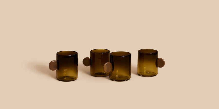 Dot Glass Set by Sticky Glass in smoke and tobacco, four hand-blown cups with round disc handles in olive and pale amber