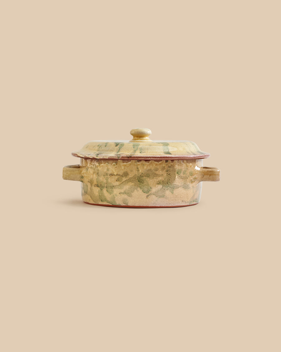 handmade tan and green oven-safe artisan clay casserole dish with leaf-like patterns