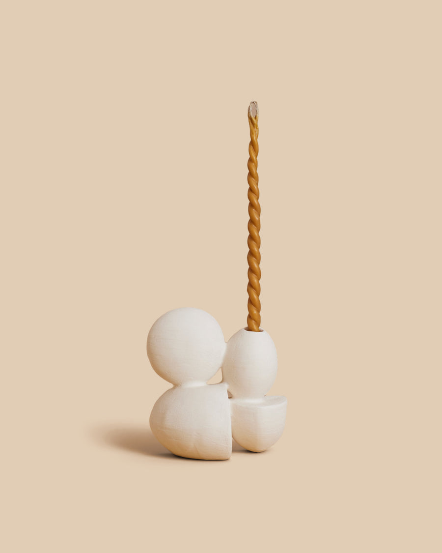 Velas N.15 by Re Jin Lee, a small white ceramic sculpture of a sphere and an egg form resting on two wedges