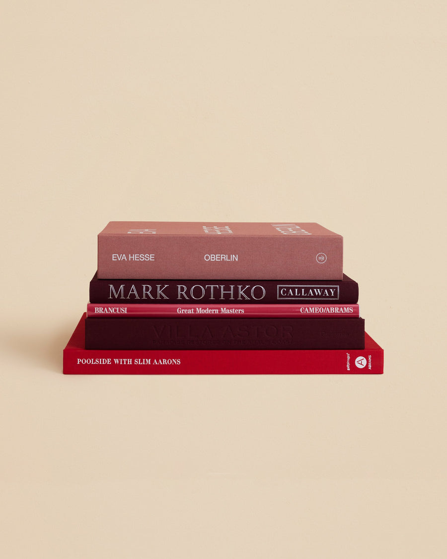 collectable stack of coffee table books with five visual and literary titles and red covers