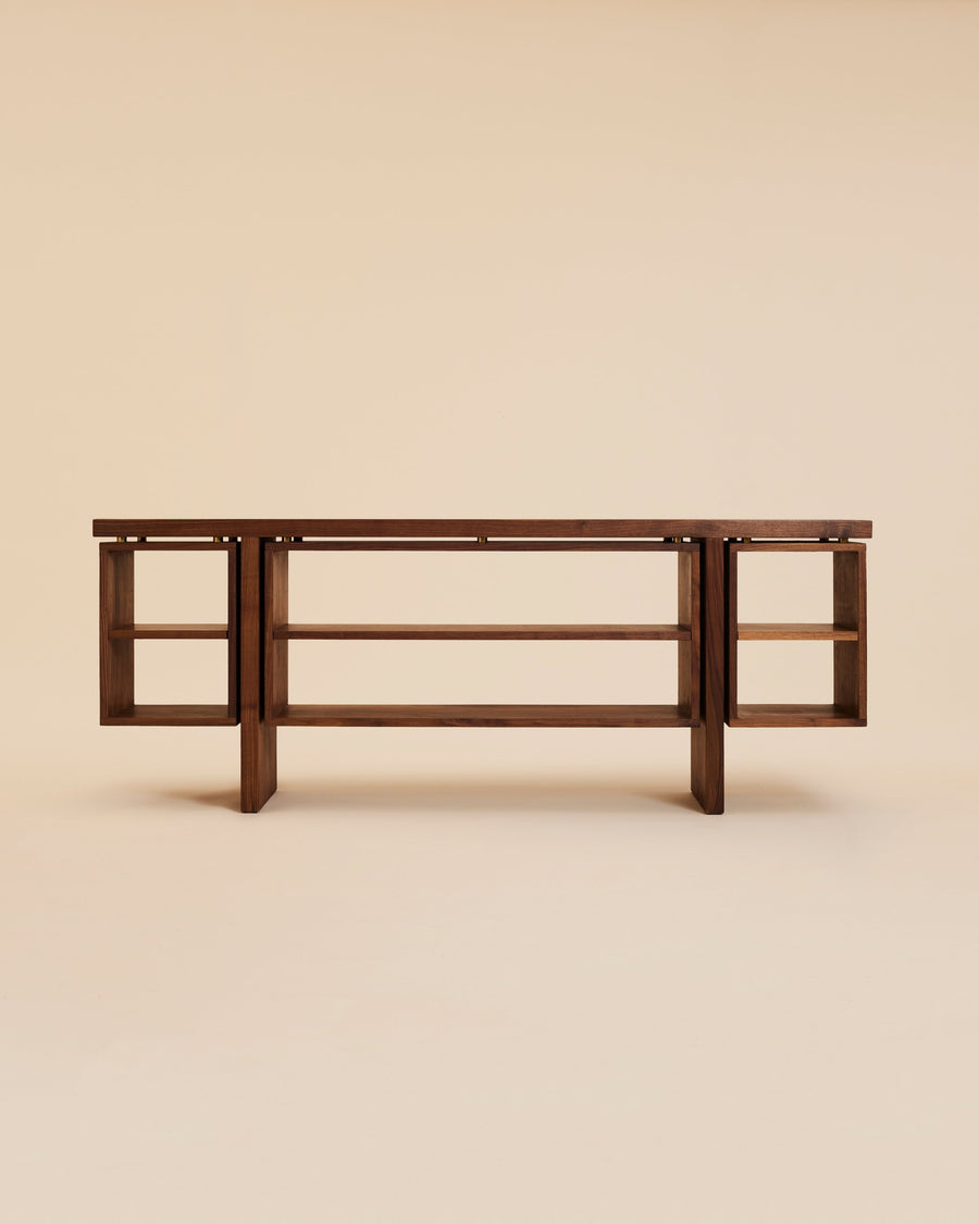 stylized image of walnut wood credenza with free-floating open shelving and bronze fittings