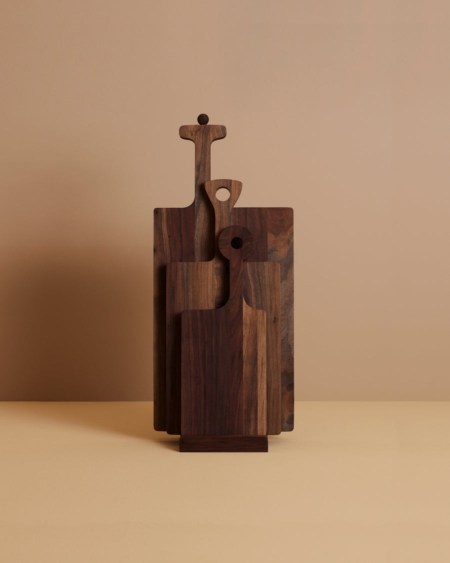 three distinctive hand oiled and waxed walnut wooden serving boards