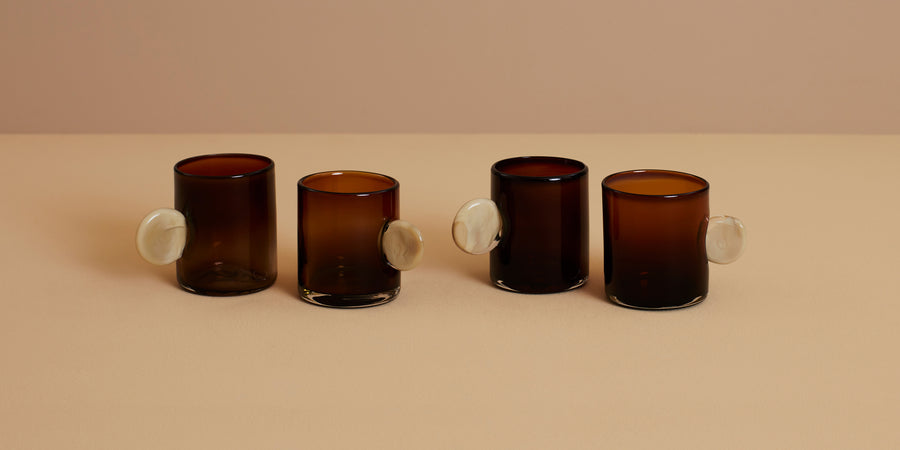 artisanal hand blown amber glassware set with cream handles