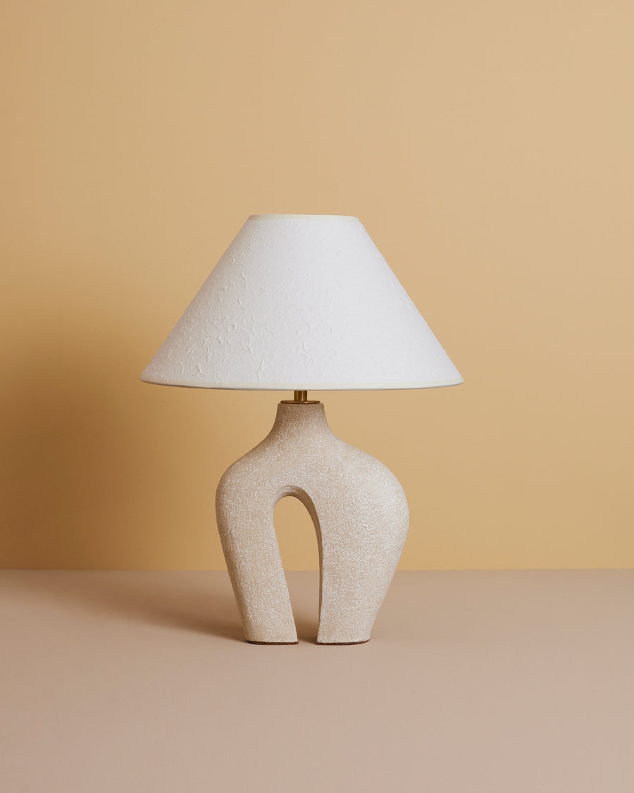 sand-colored abstract sculptural ceramic table lamp with ivory rice paper shade