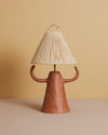 handmade Mediterranean terracotta table lamp with sculptural ceramic cone-shaped base and straw shade