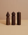 three handmade walnut wood uniquely-shaped spice, salt and pepper grinders