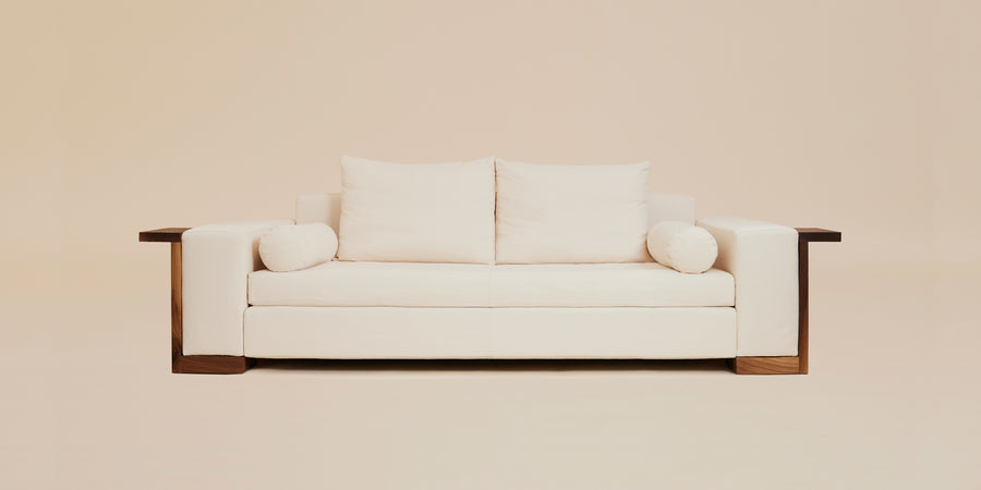 modern cream sofa with deep seats and black walnut side framing
