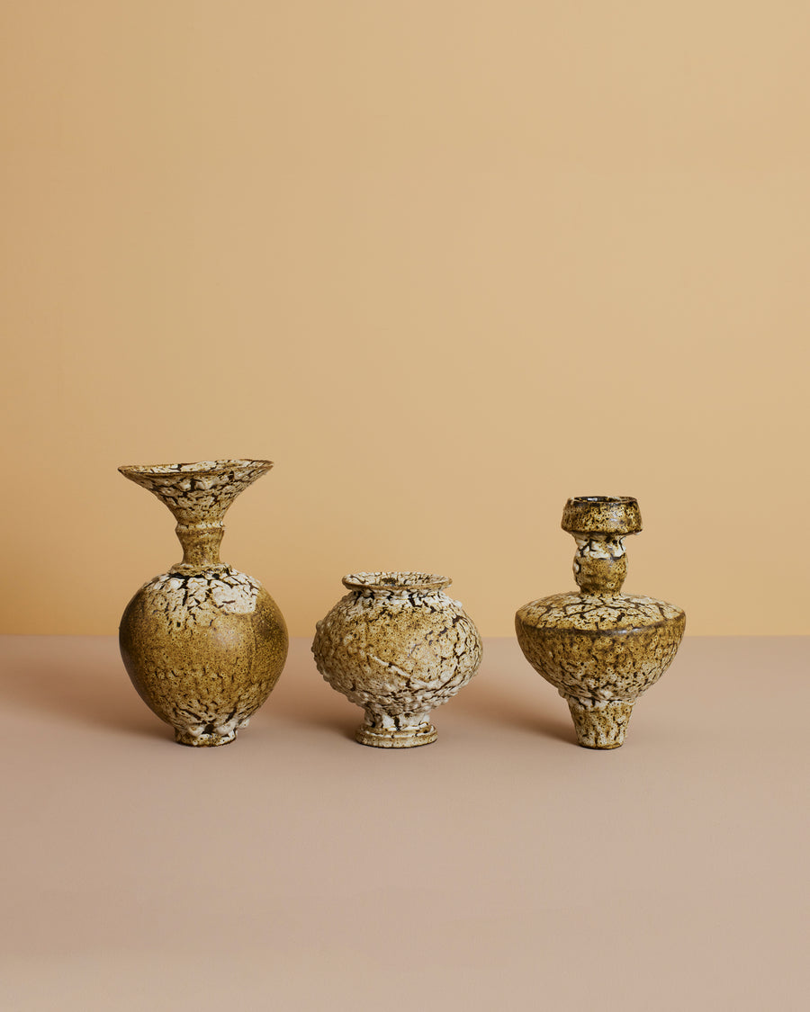 green-toned mediterranean greek pottery design ceramic artisan vase on glass table