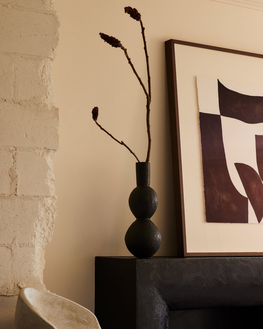 stylized image of 18.5 inch tall handcrafted black modern double-curved artisan clay vase