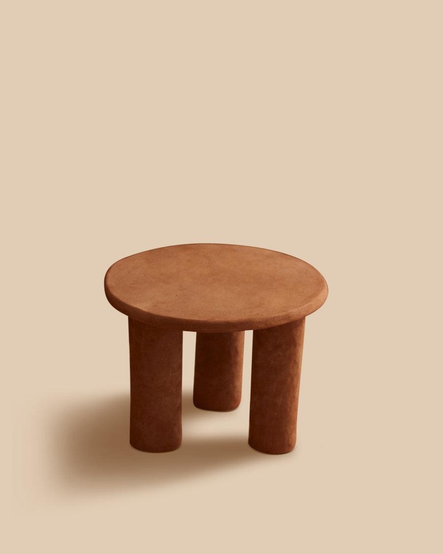 brown handmade Mediterranean stoneware round accent table on three cylindrical legs