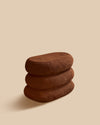 dark brown handmade Mediterranean stoneware small accent table of three stacked oval pillow shapes
