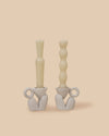 set of two natural light brown sculptural stoneware candlestick holders with handmade beeswax candles