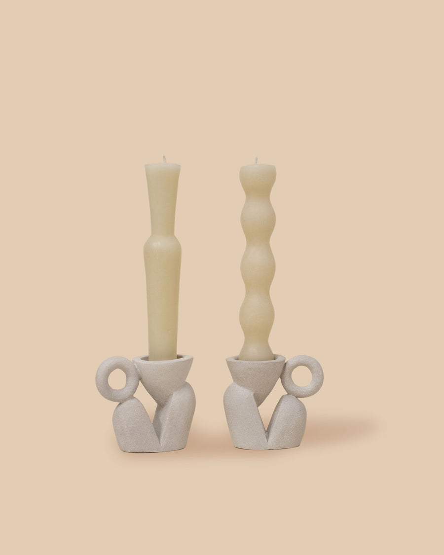 set of two natural light brown sculptural stoneware candlestick holders with handmade beeswax candles