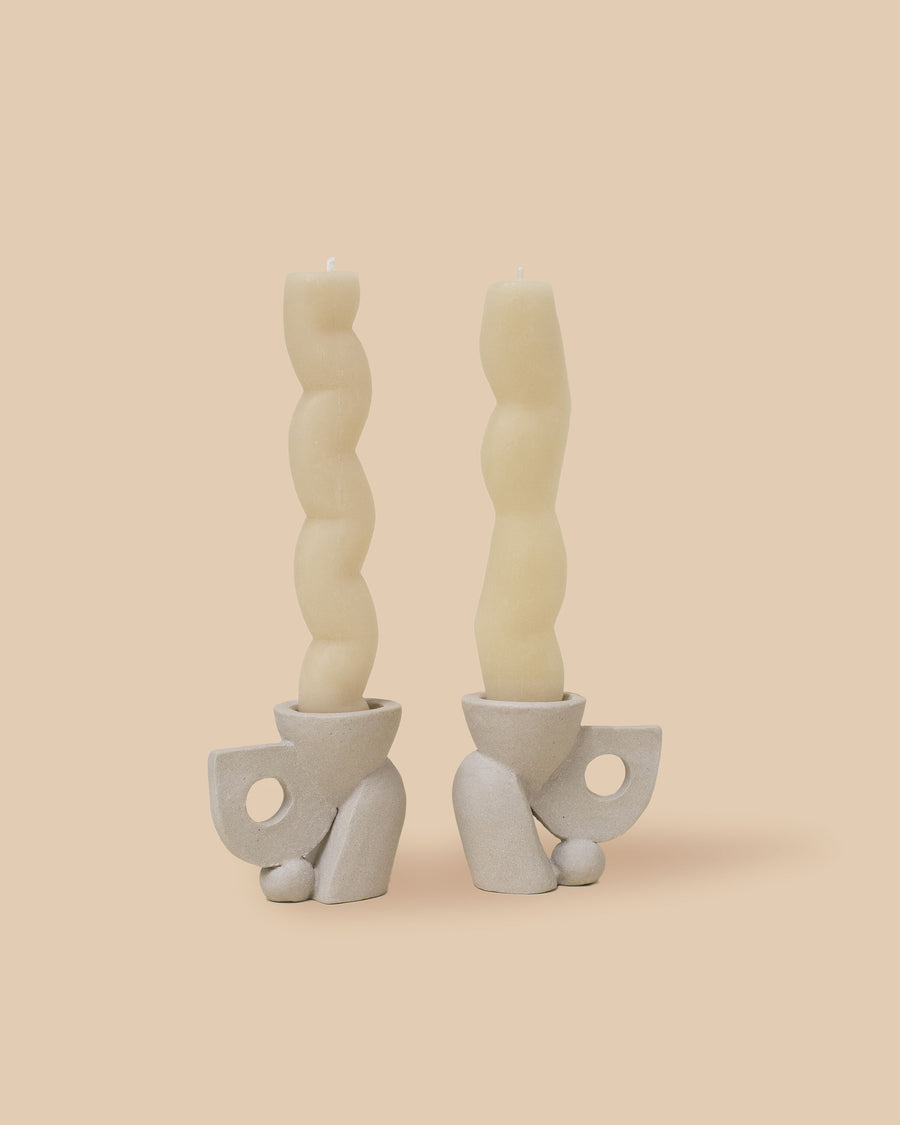 light natural brown ancient indigenous-inspired sculptural candlestick holder set and two natural colored sculptural candles