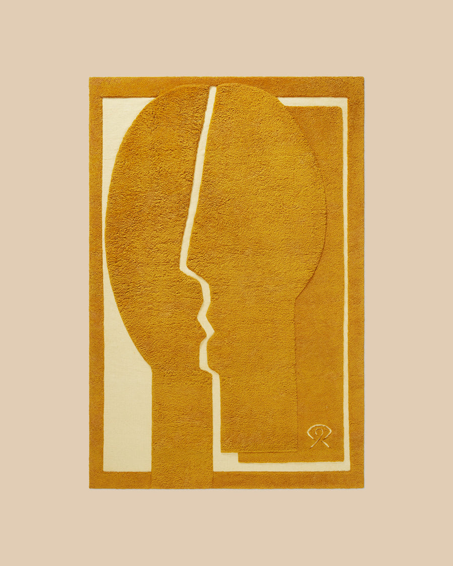 hand knotted New Zealand wool abstract rug in warm ochre with face design and shaggy pile