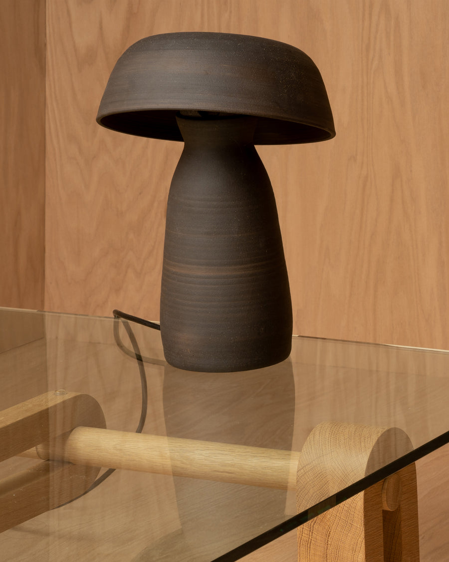 cozy handcrafted black ceramic mushroom-shaped table lamp with ambient lighting