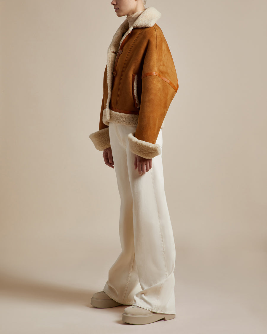  reversible women's suede jacket with camel suede and natural colored shearling drop sleeves and button closures