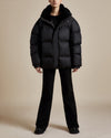 women's black nylon water resistant puffer jacket with shearling lined hood and collar