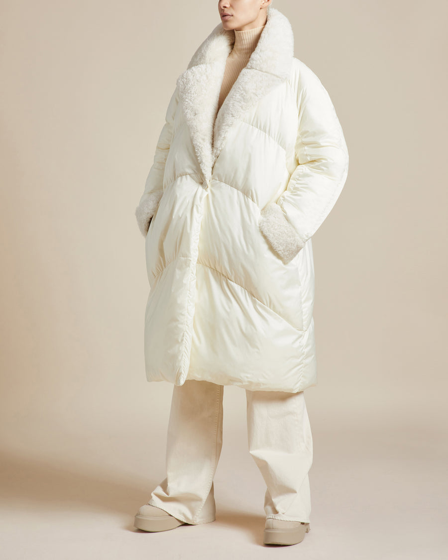 long ivory water resistant lightweight duvet style puffer coat with shearling collar and front button closure